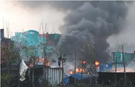  ?? Greg Baker, AFP/Getty Images ?? Fires burn at the site of an explosion in Tianjin, China, on Wednesday. A series of massive explosions at a warehouse killed 13 people, state media reported Thursday.