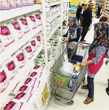  ??  ?? More pressure: A file picture showing customers buying sugar at Tesco Extra in Mutiara Damansara. TA Research says F&N is expected to face added pressure from increasing sugar prices this year.