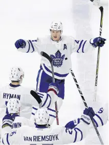  ?? GERRY BROOME/THE ASSOCIATED PRESS ?? Toronto Maple Leafs defenceman Morgan Rielly celebrates his overtime goal against the Carolina Hurricanes on Saturday in Raleigh, N.C. The goal was his fourth of the season.