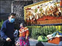  ?? ASSOCIATED PRESS ?? Locals walk past a mural dedicated to Spanish Conquistad­or Hernán Cortés, in Mexico City, Monday.