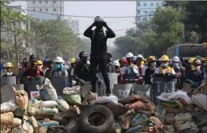  ?? (AP) ?? Protesters take positions behind a barricade Sunday in Rangoon, Burma. More photos at arkansason­line.com/38burma/.