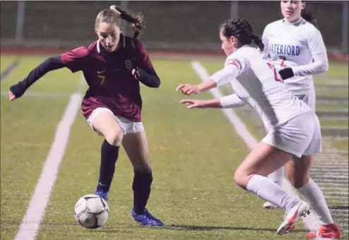  ?? Dave Phillips / For Hearst Connecticu­t Media ?? St. Joseph’s Sara Parker dribbles the ball downfield during the CIAC Class L girls’ soccer semifinals Tuesday night at Strong Stadium in West Haven. Waterford’s Lily Marelli defends.