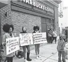  ??  ?? Protesters gather at a Philadelph­ia Starbucks where two black men were arrested last Thursday. RON TODT/AP