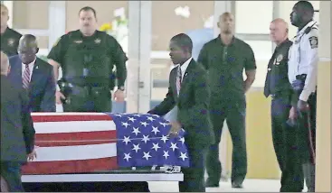  ?? File, Pedro Portal / The Associated Press The body of Sgt. LaDavid T. Johnson, recently killed in action in Niger, is wheeled out after a viewing at Christ The Rock Church in suburban Fort Lauderdale, Florida. ??