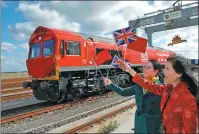  ?? PETER NICHOLLS / REUTERS ?? Well-wishers mark the departure of the first cargo train full of British exports being shipped directly to China, at the London Gateway terminal in Essex on Monday.