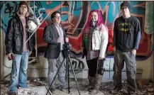  ?? Arkansas Democrat-Gazette/CARY JENKINS ?? Abandoned Arkansas photograph­ers and explorers James Kirkendall (from left), Michael Schwarz, Ginger Beck and Eddy Sisson pose in front of graffiti at the former site of the Alexander Human Developmen­t Center.