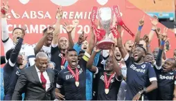  ??  ?? Bidvest Wits players hoist high their trophy.