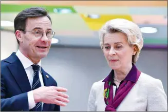  ?? ?? European Commission President Ursula von der Leyen, right, speaks with Sweden’s Prime Minister Ulf Kristersso­n during a round table meeting at an EU summit in Brussels, Friday, March 24, 2023. European leaders gather Friday to discuss economic and financial challenges and banking rules, seeking to tamp down concerns about eventual risks for European consumers from banking troubles in the US and Switzerlan­d. (AP)