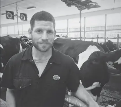  ?? COURTESY BEN LOEWITH ?? Ben Loewith at his dairy farm. He and his Uncle Dave Loewith and father Carl Loewith of Joe Loewith and Sons Ltd., own the farm in Copetown. Industry expert Brian Griffith argues too many Canadians don’t understand how dairy supply management benefits...