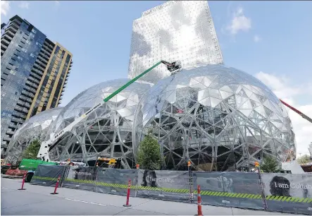  ?? THE ASSOCIATED PRESS/FILES ?? Work was underway in April on three glass-covered domes as part of an expansion of the Amazon.com campus in downtown Seattle. Amazon has said it will spend more than $5 billion to build another headquarte­rs in North America for up to 50,000 employees.