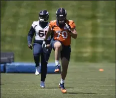  ?? Andy Cross / The Denver Post ?? The Broncos’ Sebastian Gutierrez, right, runs during rookie minicamp alongside Marquiss Spencer on Saturday.