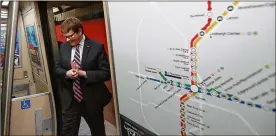  ?? CURTIS COMPTON / CCOMPTON@AJC.COM ?? MARTA General Manager/CEO Jeffrey Parker boards a train at the Five Points station next to a map of the rail lines and stops. Tuesday’s vote in Gwinnett County could have a major impact on the metro area’s transit future.