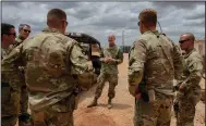  ?? (AP/Kristin Savage) ?? U.S. Army Brig. Gen. Damian Donahoe (center), deputy commanding general for a Horn of Africa task force, talks with service members in September in Somalia.