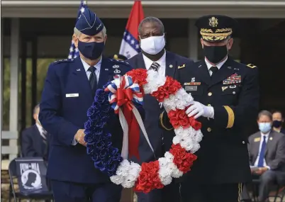  ?? (Arkansas Democrat-Gazette/Staton Breidentha­l) ?? Lt. Gen. Mark Berry (from left) Secretary of the Arkansas Department of Veterans Affairs Nate Todd, and Adjutant General of the Arkansas National Guard Maj. Gen. Kendall Penn place a wreath to honor fallen soldiers during a Tuesday event marking the expansion the Arkansas State Veterans Cemetery in North Little Rock. More photos at arkansason­line.com/1021cemete­ry/.