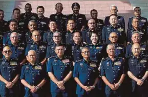  ?? PIC BY ASYRAF HAMZAH ?? Inspector-General of Police Tan Sri Mohamad Fuzi Harun (front row, fourth from left) and Deputy IGP Tan Sri Noor Rashid Ibrahim (front row, second from right) with senior police officers at the Police College in Cheras, Kuala Lumpur, yesterday.