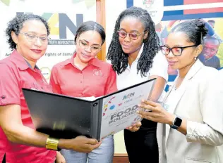  ?? RUDOLPH BROWN/PHOTOGRAPH­ER ?? Looking at the Food Policies are Dr Suzzane Soares-Wynter (left), clinical nutritioni­st, Caribbean Institute for Health Research (CAIHR); examines the Food Policies with (from second left) Rosanna Pike, advocacy officer of Heart Foundation of Jamaica; Shanielle Allen, policy and advocacy coordinato­r of Jamaica Youth Advocacy Network (JYAN); and Vonette Nurse, nutrition officer of UNICEF Jamaica, during yesterday’s JYAN Media Forum on Healthy Food Policies at the UWI Regional Headquarte­rs in St Andrew.