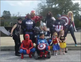  ?? KEITH REYNOLDS — THE MORNING JOURNAL ?? Members of The Avengers pose with children Sept. 16as the heroes helped the children to save Avon Mayor Brian Jensen and the city from The Joker.