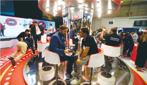  ?? (Rafael Marchante/Reuters) ?? ATTENDEES SPEAK at Portuguese electricit­y company EDP’s booth during the Web Summit in Lisbon last week. Lisbon has earned the right to host Europe’s biggest tech conference, Web Summit, this month. Now hopes are high that this will accelerate...