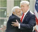  ?? — Reuters ?? Prime Minister Narendra Modi hugs US President Donald Trump as they give joint statements in the Rose Garden of the White House in Washington, on June 26.