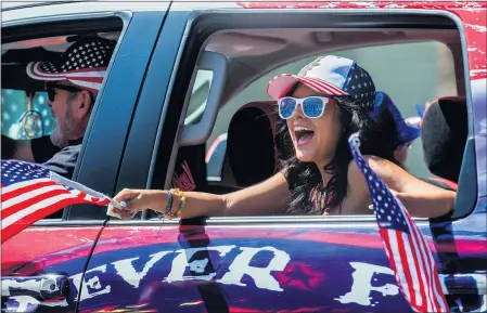  ?? TERRY PIERSON — STAFF PHOTOGRAPH­ER ?? A girl yells holiday wishes to onlookers from a truck in the parade along Bonita Avenue during La Verne’s “United We Stand” Fourth of July celebratio­n on Saturday. Some cities held parades and events prior to today’s planned festivitie­s, which will occur in several parts of Los Angeles County.