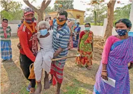  ?? PTI ?? An elderly voter is carried to a polling booth at Birbhum district’s Bandhlodan­ga for casting vote during the 8th phase of the Assembly elections on Thursday. —