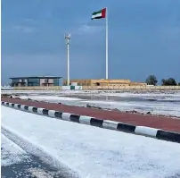  ??  ?? An Umm Al Quwain road covered with hailstones on Sunday. — Photos courtesy: Khalid Al Zarei, UAQ Executive Council