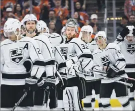  ?? Jeff McIntosh Associated Press ?? KINGS GOALIE Jonathan Quick (32) and teammates watch as the Edmonton Oilers celebrate winning Game 7 to clinch their first-round playoff series.