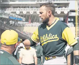  ?? JIM MONTE — THE ASSOCIATED PRESS ?? The A’s Jed Lowrie is greeted in the dugout after smacking a solo homer in the seventh inning of Sunday’s win — Lowrie’s 21st homer of the year. Lowrie had three RBIs.