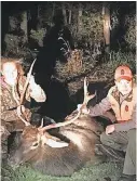  ?? DONALD WHITE ?? Abby Wilson, with MDC agent Adam Doerhoff, accidental­ly shot this bull elk Saturday, thinking it was a big white-tail buck.