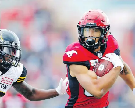  ?? LEAH HENNEL ?? The attitude and work ethic of receiver Reggie Begelton, right, has caught the attention of his Calgary Stampeders teammates.