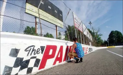  ?? JONATHAN TRESSLER — THE NEWS-HERALD ?? Randy Maggio, Jr., who does promotions and a little bit of everything else at The Painesvill­e Speedway, 500 Fairport Nursery Road in Painesvill­e Township, does some touch-up work around the track in this May 31 photo.