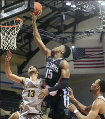  ?? PHELAN M. EBENHACK — THE ASSOCIATED PRESS ?? Villanova forward Saddiq Bey (15) goes up for a shot between Canisius guards Isaiah Reese, left, and Takal Molson Thursday.