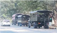  ?? AUNG SHINE OO THE ASSOCIATED PRESS ?? Soldiers sit inside trucks parked on a road in Naypyitaw, the Myanmar capital, on Monday.