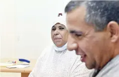  ??  ?? Aicha, 62, who has had a kidney transplant­ed from her son (right) talks to medical staff at Batna’s university hospital’s nephrology department in Algiers.