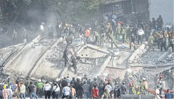  ?? AFP ?? RIGHT Rescue teams look for people trapped in the rubble after the earthquake in Mexico City, on the anniversar­y of the 1985 tremor that killed thousands.