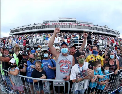  ?? Maddie Meyer/Getty Images North America/TNS, File ?? Fans wearing masks and face coverings cheer during the NASCAR Cup Series Foxwoods Resort Casino 301 at New Hampshire Motor Speedway on Aug. 2, 2020, in Loudon, N.H.