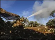  ?? GHAITH ALSAYED — THE ASSOCIATED PRESS ?? Turkish-backed rebel fighters fire a howitzer toward Syrian government forces near the village of Neirab in Idlib province, Syria, on Thursday.