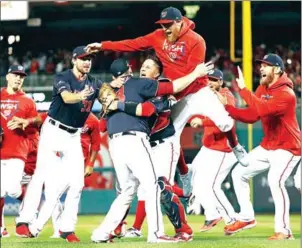  ?? GETTY IMAGES/AFP ?? The Washington Nationals celebrate winning game four of the National League Championsh­ip Series at Nationals Park on Tuesday in Washington, DC.