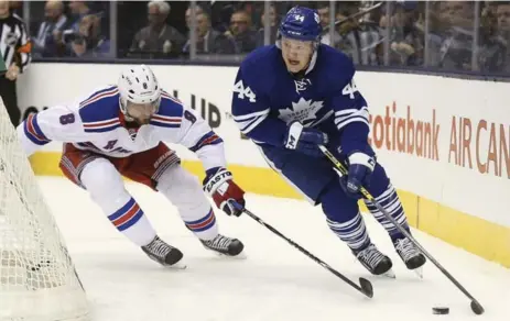  ?? RICHARD LAUTENS/TORONTO STAR ?? Maple Leafs defenceman Morgan Rielly, right, races New York Rangers defender Kevin Klein behind the net during action Tuesday night at the ACC.