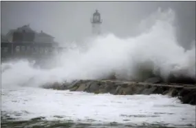  ?? STEVE SENNE — ASSOCIATED PRESS ?? Waves crash against a seawall near the Scituate Lighthouse in Scituate, Mass., on Friday.