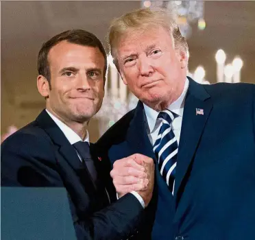  ?? — AP ?? Bromantic overtures: Macron literally and figurative­ly stroked Trump, with the goal of getting him to preserve the Iran nuclear deal, on his state visit to the US last month.