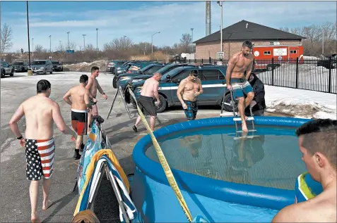  ?? MIKE NOLAN/DAILY SOUTHTOWN ?? Tinley Park police officers prepare to jump into a pool Friday outside the station as part of a fundraiser for Special Olympics Illinois.