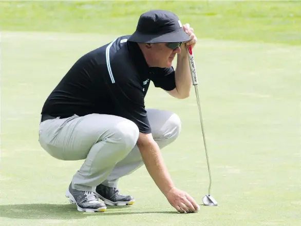  ??  ?? Doug Morgan, a club profession­al, instructor and teacher, lines up a putt at the B.C. Senior’s Championsh­ips at Salmon Arm Golf Club on Tuesday.