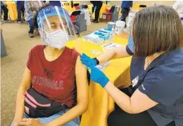  ?? JOSHUA EMERSON SMITH U-T ?? Elementary school teacher Tinika Hagler, 46, of Spring Valley gets her shot at the vaccinatio­n superstati­on run by Sharp Healthcare in Chula Vista.