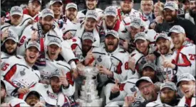  ?? JOHN LOCHER — THE ASSOCIATED PRESS ?? Members of the Capitals pose with the Stanley Cup after they defeated the Golden Knights 4-3 in Game 5 of the Stanley Cup Finals.