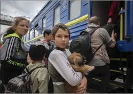  ?? EFREM LUKATSKY — THE ASSOCIATED PRESS ?? A boy holds his pet dog as his family is evacuated from the war-hit Pokrovsk in eastern Ukraine on Saturday.