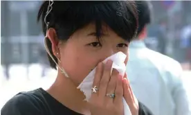  ?? ?? A woman blows her nose on a Tokyo street. Japan’s prime minister has declared war on hay fever Photograph: Katsumi Kasahara/AP