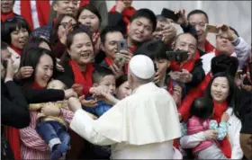  ?? GREGORIO BORGIA — THE ASSOCIATED PRESS FILE ?? Pope Francis meets a group of faithful from China at the end of his weekly general audience in St. Peter’s Square, at the Vatican. On Saturday the Vatican announced it had signed a “provisiona­l agreement” with China on the appointmen­t of bishops, a breakthrou­gh on an issue that for decades fueled tensions between the Holy See and Beijing and thwarted efforts toward diplomatic relations.