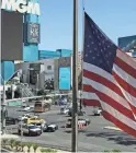  ??  ?? An American flag waves near a police barricade on Oct. 2, 2017, on the Las Vegas Strip after a mass shooting. AP