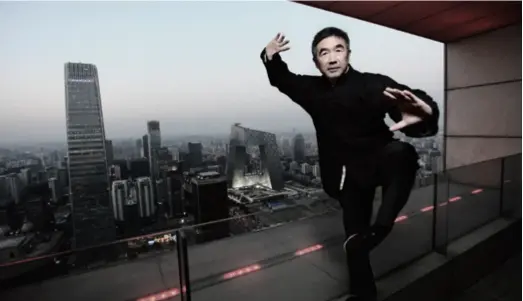  ??  ?? Zhong Haiming makes a posture of tai chi in a building in Beijing in 2012